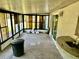 Enclosed patio features an outdoor sink, tile flooring, and a wall of windows letting in plenty of natural light at 8537 Horizon Ln, Hudson, FL 34667