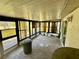 Enclosed patio features an outdoor sink, tile flooring, and a wall of windows letting in plenty of natural light at 8537 Horizon Ln, Hudson, FL 34667