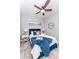 Charming bedroom featuring a blue bed frame, ceiling fan, and tasteful decor, with a bright, inviting atmosphere at 901 Eagle Ln, Apollo Beach, FL 33572