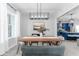Elegant dining room with modern lighting and an open view of the kitchen at 901 Eagle Ln, Apollo Beach, FL 33572