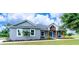 Charming single-story home features a covered porch and well-manicured lawn at 901 Eagle Ln, Apollo Beach, FL 33572