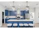 Stunning kitchen features blue cabinets, stainless steel appliances and pendant lighting at 901 Eagle Ln, Apollo Beach, FL 33572