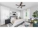 Light, airy main bedroom with a ceiling fan, accent rug, and white and gray color scheme at 901 Eagle Ln, Apollo Beach, FL 33572