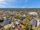 Scenic aerial view showcases the property's proximity to local businesses, a nearby lake, and lush landscaping at 921 7Th Nw St, Largo, FL 33770