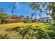 Large backyard with green grass and a wood fence at 921 7Th Nw St, Largo, FL 33770