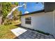 Backyard featuring the exterior of the home and a quaint stone paver patio at 921 7Th Nw St, Largo, FL 33770