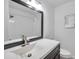 Modern bathroom with nice fixtures, a large mirror, and a tiled shower at 921 7Th Nw St, Largo, FL 33770