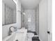 Nicely updated bathroom with new vanity and modern shower with white and black geometric patterned tiles at 921 7Th Nw St, Largo, FL 33770