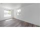 Bright bedroom with laminate flooring, white walls, and natural light from large windows at 921 7Th Nw St, Largo, FL 33770