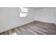 Bright bedroom featuring laminate flooring, large window, fresh white paint, and closet space at 921 7Th Nw St, Largo, FL 33770