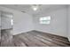 Bedroom with modern floors, a ceiling fan, and a bright window for lots of natural light at 921 7Th Nw St, Largo, FL 33770