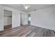 Bedroom featuring modern floors, a ceiling fan, and access to closets and other rooms at 921 7Th Nw St, Largo, FL 33770
