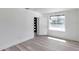 Bedroom with laminate flooring, white walls, a new window, and views into the front of the house at 921 7Th Nw St, Largo, FL 33770