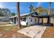A single-story home showing driveway with covered parking along the side of the house at 921 7Th Nw St, Largo, FL 33770