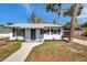 Charming single-story home with a well-maintained lawn, modern front door, and inviting curb appeal at 921 7Th Nw St, Largo, FL 33770