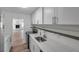 Bright kitchen with white cabinets, granite countertops, and stainless steel appliances at 921 7Th Nw St, Largo, FL 33770