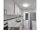 Modern kitchen featuring stainless steel appliances, white cabinets and granite countertops at 921 7Th Nw St, Largo, FL 33770