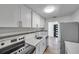 A modern kitchen featuring a stainless steel refrigerator, white cabinets and countertops at 921 7Th Nw St, Largo, FL 33770