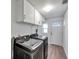 Functional laundry room with cabinets and a black side-by-side washer and dryer at 921 7Th Nw St, Largo, FL 33770