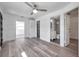 Living room featuring laminate flooring with views into the bathroom, kitchen, and front door at 921 7Th Nw St, Largo, FL 33770