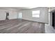 Spacious living room with modern floors, bright white walls, and sliding glass doors at 921 7Th Nw St, Largo, FL 33770