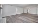 Open living area boasts modern flooring, bright walls, and access to other rooms at 921 7Th Nw St, Largo, FL 33770