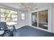 Enclosed sunroom with large windows, ceiling fan, and sliding glass doors at 921 7Th Nw St, Largo, FL 33770