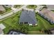 Aerial view of a well-maintained home with a fenced yard, tropical landscaping and screened in lanai at 6927 Crestpoint Dr, Apollo Beach, FL 33572