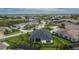 Aerial view of a home with a fenced-in backyard, screened lanai, and lush landscaping in quiet neighborhood at 6927 Crestpoint Dr, Apollo Beach, FL 33572