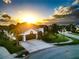 Beautiful home with palm trees, and a two-car garage, bathed in golden sunlight at 6927 Crestpoint Dr, Apollo Beach, FL 33572