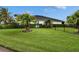 Expansive backyard with lush grass and black metal fence at 6927 Crestpoint Dr, Apollo Beach, FL 33572