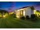 Backyard at dusk featuring manicured landscaping and subtle landscape lighting at 6927 Crestpoint Dr, Apollo Beach, FL 33572