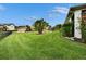 View of the backyard with a meticulously maintained lawn and mature landscaping at 6927 Crestpoint Dr, Apollo Beach, FL 33572