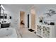 Bright, open bathroom with tub, separate shower, contrasting vanity, and neutral tile at 6927 Crestpoint Dr, Apollo Beach, FL 33572
