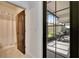 View through bathroom door to screened lanai featuring dining table and pleasant backyard view at 6927 Crestpoint Dr, Apollo Beach, FL 33572