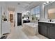 Bright bathroom with undermount tub, contrasting dark vanities, and a window providing natural light at 6927 Crestpoint Dr, Apollo Beach, FL 33572