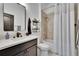 Bathroom with shower-tub, updated sink, mirror and shelving unit at 6927 Crestpoint Dr, Apollo Beach, FL 33572