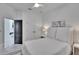Well-lit bedroom with light-colored walls and decor, featuring a ceiling fan at 6927 Crestpoint Dr, Apollo Beach, FL 33572
