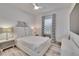 Well-lit bedroom with light-colored walls and decor, featuring a ceiling fan at 6927 Crestpoint Dr, Apollo Beach, FL 33572