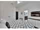 Bedroom with ceiling fan, TV, and ensuite bathroom with black hardware at 6927 Crestpoint Dr, Apollo Beach, FL 33572