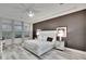 Modern bedroom features a neutral palette, light wood floors, and expansive windows with natural light at 6927 Crestpoint Dr, Apollo Beach, FL 33572