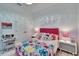 Bright bedroom with a ceiling fan, colorful bedding, and a study area at 6927 Crestpoint Dr, Apollo Beach, FL 33572