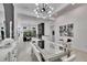 Open-concept living space featuring a dining area with statement lighting and modern decor at 6927 Crestpoint Dr, Apollo Beach, FL 33572