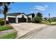 Wide driveway leading to a lovely two-story home featuring black trim and lush landscaping at 6927 Crestpoint Dr, Apollo Beach, FL 33572