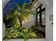 Lush entryway featuring mature landscaping, a palm tree, and well-maintained beds at 6927 Crestpoint Dr, Apollo Beach, FL 33572