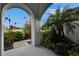 Arched entryway featuring vibrant foliage framing a view of a meticulously landscaped neighborhood at 6927 Crestpoint Dr, Apollo Beach, FL 33572