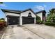 Beautiful black and white home with a two-car garage and lovely landscaping at 6927 Crestpoint Dr, Apollo Beach, FL 33572