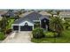 Beautiful home with a two-car garage, manicured lawn, and mature landscaping at 6927 Crestpoint Dr, Apollo Beach, FL 33572
