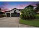 Charming home featuring a well-manicured lawn and a spacious two-car garage at 6927 Crestpoint Dr, Apollo Beach, FL 33572