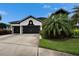 Charming home featuring a two-car garage, a manicured lawn, and beautiful landscaping at 6927 Crestpoint Dr, Apollo Beach, FL 33572